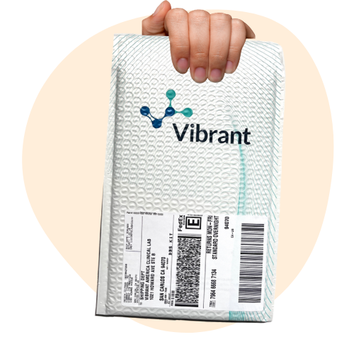 Hand holding a white package labeled 'Vibrant' with a molecular logo.